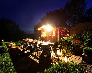 Romantisch verlicht terras bij nacht bij Chez Mari-Jo vakantiehuis in Saint-Jacques, Ardennen, Belgi.